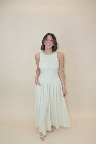 Woman in a white dress lying on a beige surface