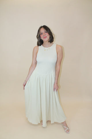 Woman in a white dress lying on a beige floor