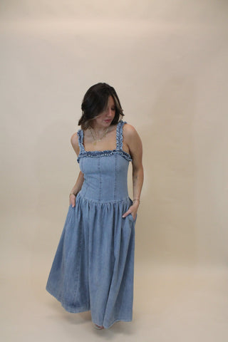 Woman wearing a blue dress against a plain background