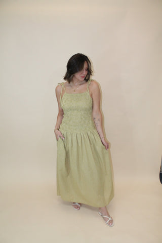 Woman lying on a yoga mat with a neutral background